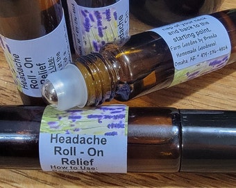 May include: A brown glass roll-on bottle with a white label that says "Headache Roll-On Relief" and instructions on how to use it. The label also features a lavender flower design.