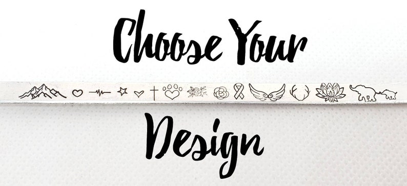 May include: Choose Your Design. A row of 14 different small design options for jewelry, including mountains, a heart, a star, a cross, paw prints, a flower, a rose, a ribbon, wings, antlers, a lotus flower, and elephants.