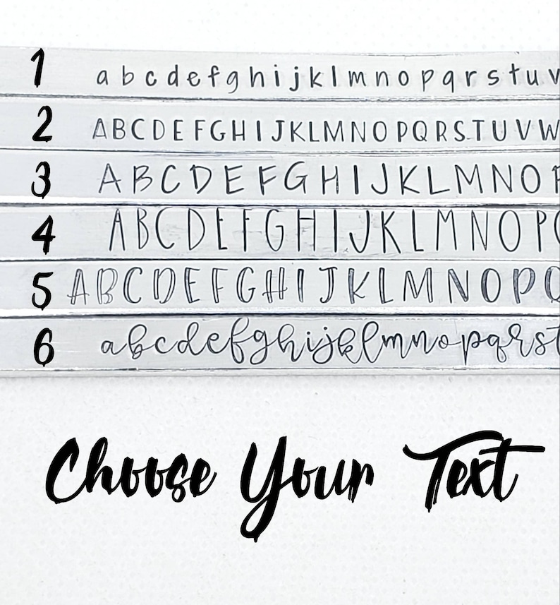 May include: A white wooden sign with six rows of letters, each row numbered 1 through 6. The letters are in different fonts and sizes. The letters are in black. The sign says "Choose Your Text".