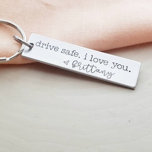 May include: Silver keychain with the text "drive safe. i love you. ♥ brittany"