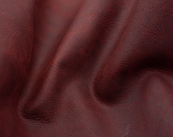 Veg tan pull up leather sheets in dark red color . Distress, full grain, vintage vegetable tanned leather pieces in wine red color