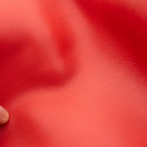 Red leather sheets in  red color with a very discrete coud effect. Genuine  leather panels in red color for DIY  and leather crafts
