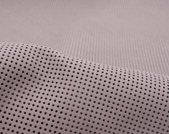 Perforated nappa  leather sheets in beige-gray. Genuine leather pieces with round holes