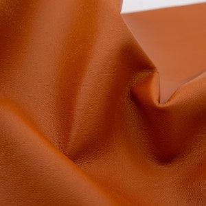 Nappa leather sheets in light brown color. Soft smooth genuine leather pieces in gingerbread brown color