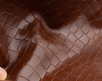 Croco pattern real leather sheets in cognac brown .Smooth high quality leather panels with crocodile pattern for diy crafts