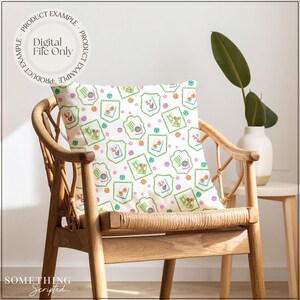 May include: A decorative pillow with a repeating pattern of green, pink, and orange floral and geometric designs. The pillow is on a wooden chair. The text "PRODUCT EXAMPLE" and "DIGITAL FILE ONLY" are printed on the top left of the image. The text "SOMETHING SCRIPTED" is printed on the bottom left.