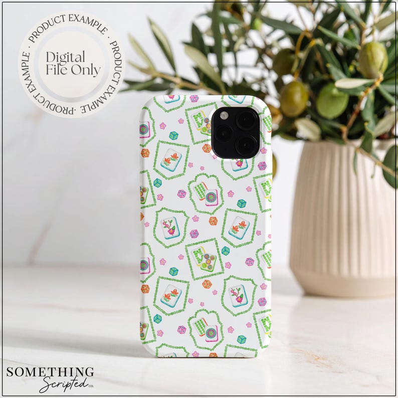 May include: White phone case with a repeating pattern of green, pink, and orange floral and geometric designs. The case has a black camera lens and the text "PRODUCT EXAMPLE" and "Digital File Only". The brand name "SOMETHING Scripted" is at the bottom.