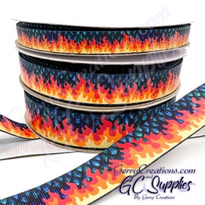 May include: Spools of ribbon with a flame design. The ribbon features a black background with orange, red, and yellow flames. The ribbon is approximately 1 inch wide. The image also includes the text "GerryCreations.com and GC Supplies by Gerry Creations."