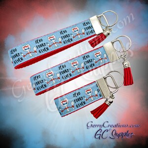May include: Four blue and red keychains with a white cartoon character holding a spoon and fork. The keychains have the text "Zero Forks Given" printed on them.