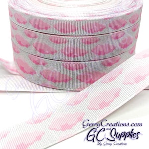 May include: White ribbon with a pink and white cloud print. The ribbon is rolled up and the ends are visible. The ribbon is 1.5 inches wide.