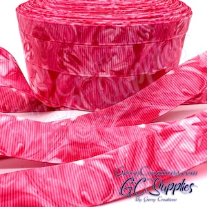 May include: A roll of pink ribbon with a vertical ribbed texture and a white floral pattern. The ribbon is unrolled in the foreground, revealing the pattern. The text "GerryCreations.com" and "GC Supplies" is visible.