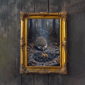 May include: A framed painting depicts a hedgehog near a small fire in a forest setting. The painting is in a gold ornate frame. The hedgehog is in the center of the image, with a fire in front of it. The background shows a forest with tall trees.