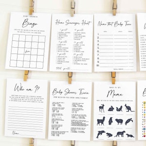 Puede incluir: Una colecci&oacute;n de tarjetas de juegos para baby shower, impresas en tinta negra sobre papel blanco. Los juegos incluyen Bingo, B&uacute;squeda del tesoro en casa, Nombra esa melod&iacute;a de beb&eacute;, &iquest;Qui&eacute;n soy yo?, Baby Shower Trivia y &iquest;Qui&eacute;n es mi mam&aacute;?. Las tarjetas est&aacute;n sujetas con pinzas de madera.