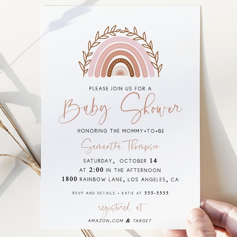 May include: A baby shower invitation with a pink, brown, and white rainbow illustration. The text reads "Please join us for a Baby Shower honoring the mommy-to-be Samantha Thompson Saturday, October 14 at 2:00 in the afternoon 1800 Rainbow Lane, Los Angeles, CA RSVP and details - Katie at 555-5555 registered at AMAZON.COM & TARGET"