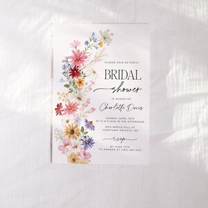 Wildflower bridal shower bundle including invitation, recipe card, registry card and recipe request card. The invitation includes colorful watercolor wildflower illustration in pink, purple, yellow, red and green shades and modern calligraphy text style and simple white background. The text read "bridal shower". The size of the invitation is 5x7 inches, recipe card and registry card are 3.5x5 inches and recipe request card is 2x3.5 inches.