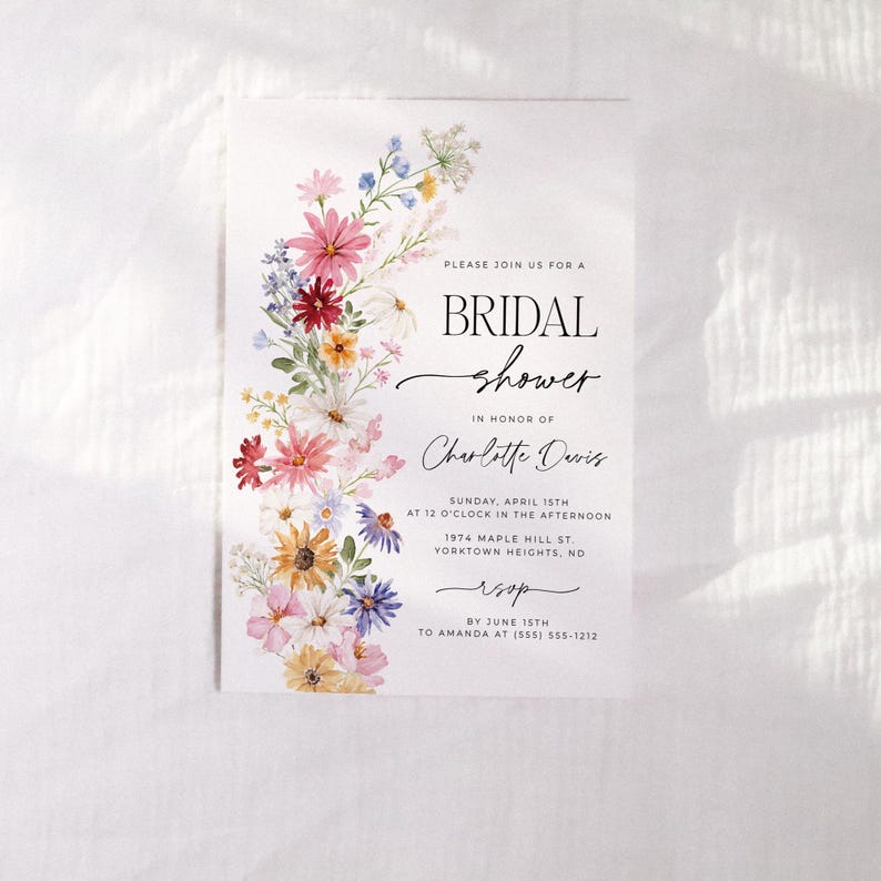 Wildflower bridal shower bundle including invitation, recipe card, registry card and recipe request card. The invitation includes colorful watercolor wildflower illustration in pink, purple, yellow, red and green shades and modern calligraphy text style and simple white background. The text read "bridal shower". The size of the invitation is 5x7 inches, recipe card and registry card are 3.5x5 inches and recipe request card is 2x3.5 inches.