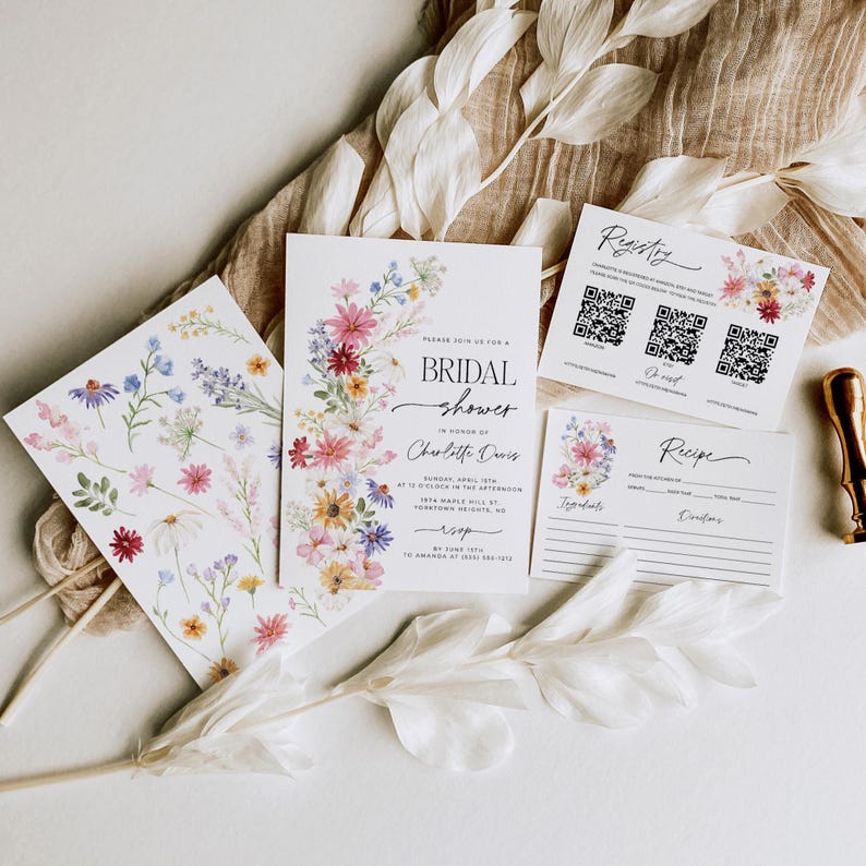 Wildflower bridal shower bundle including invitation, recipe card, registry card and recipe request card. The invitation includes colorful watercolor wildflower illustration in pink, purple, yellow, red and green shades and modern calligraphy text style and simple white background. The text read "bridal shower". The size of the invitation is 5x7 inches, recipe card and registry card are 3.5x5 inches and recipe request card is 2x3.5 inches.