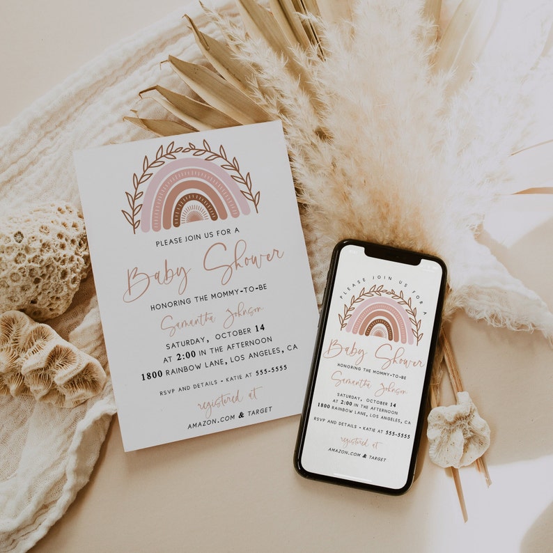 May include: A pink and brown rainbow with a leafy border on a white card. The card is a baby shower invitation for Samantha Johnson. The invitation includes the date, time, location, and RSVP information. The text "registered at Amazon.com & Target" is also included.
