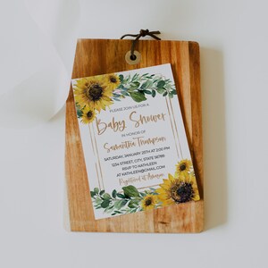 May include: A baby shower invitation with a sunflower and greenery design. The invitation reads "Please join us for a Baby Shower in honor of Samantha Thompson. Saturday, January 25th at 2:00 PM. 1234 Street, City, State 56789. RSVP to Kathleen at Kathleen@gmail.com. Registered at Amazon."