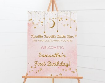 May include: Pink and gold welcome sign with a crescent moon and stars. The sign says "Twinkle Twinkle Little Star One Year Old Is What You Are! Welcome To Samantha's First Birthday!"