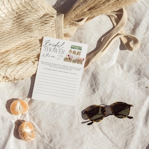 May include: A white card with black text that reads "Bridal Shower Who am I?"  Write down your name and a personal memory you have with the bride-to-be. I will be read aloud, the bride will try to guess who you are. If the bride cannot guess correctly, you win!