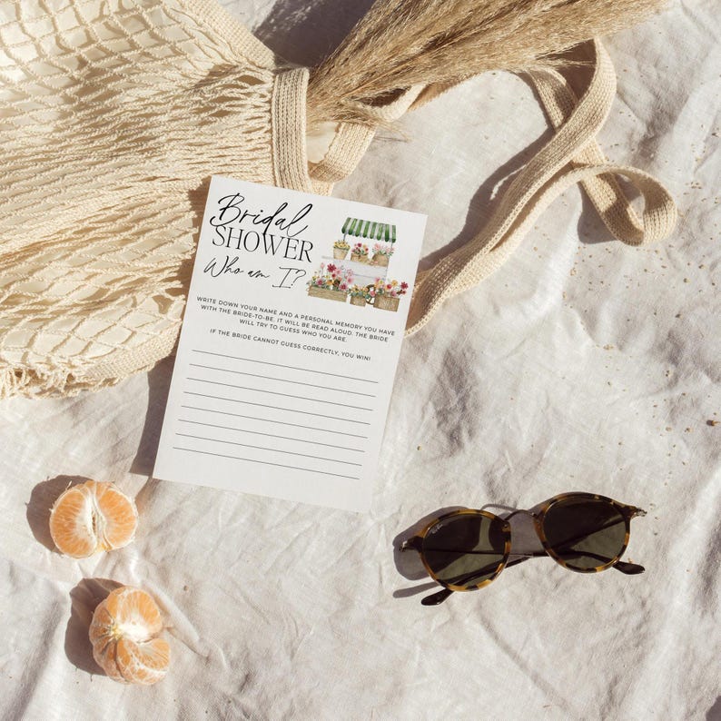 May include: A white card with black text that reads "Bridal Shower Who am I?"  Write down your name and a personal memory you have with the bride-to-be. I will be read aloud, the bride will try to guess who you are. If the bride cannot guess correctly, you win!