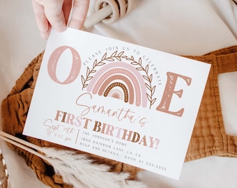 May include: A pink and brown first birthday invitation with a rainbow and the text "PLEASE JOIN US TO CELEBRATE Samantha's FIRST BIRTHDAY! Sept 15th at 4:00 pm THE JOHNSON'S HOME 1800 RAINBOW LANE, LA, CA RSVP AND DETAILS KATIE AT 555-5555"