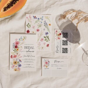 Wildflower bridal shower bundle including invitation, recipe card, registry card and recipe request card. The invitation includes colorful watercolor wildflower illustration in pink, purple, yellow, red and green shades and modern calligraphy text style and simple white background. The text read "bridal shower". The size of the invitation is 5x7 inches, recipe card and registry card are 3.5x5 inches and recipe request card is 2x3.5 inches.