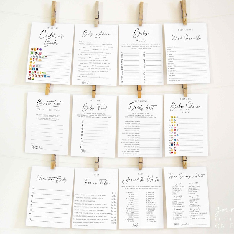 Puede incluir: Un conjunto de tarjetas de juegos para baby shower, con t&iacute;tulos como "Adivina los libros infantiles" y "Consejos para el beb&eacute;". Las tarjetas est&aacute;n impresas en tinta negra sobre papel blanco y sujetas con pinzas de madera.