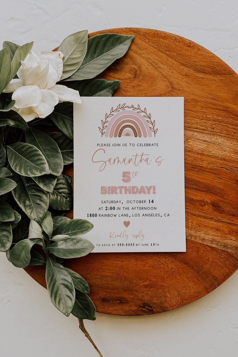 May include: A white card with a pink and brown rainbow design. The text on the card reads "Please join us to celebrate Samantha's 5th Birthday! Saturday, October 14 at 2:00 in the afternoon 1800 Rainbow Lane, Los Angeles, CA Kindly reply to Katie at 555-5555 by June 15th".