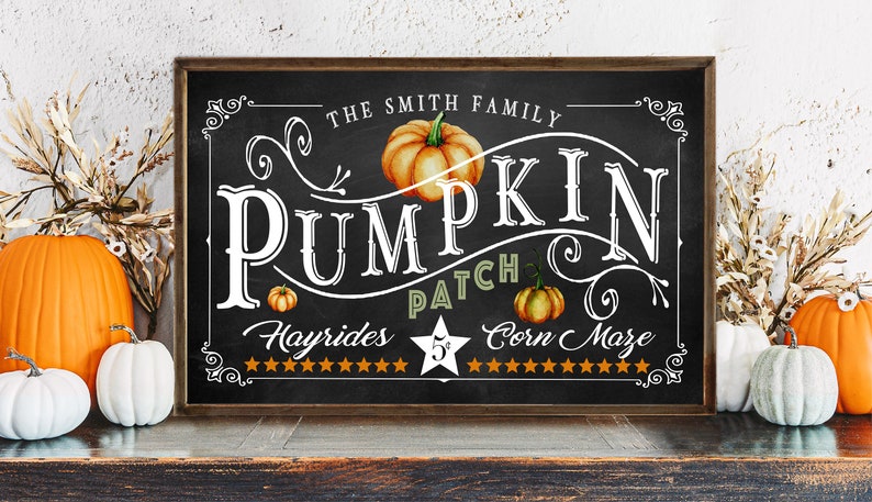 May include: A black chalkboard sign with white lettering that reads "The Smith Family Pumpkin Patch Hayrides 5&cent; Corn Maze". The sign is decorated with a brown wooden frame and a drawing of a pumpkin.