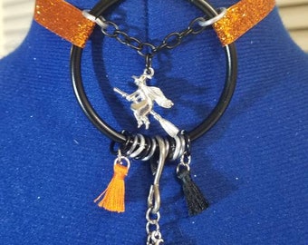 Halloween witch themed glitter orange ribbon choker collar with black ring.