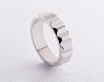 May include: A silver ring with a textured, geometric design. The ring is made of metal and has a polished finish.