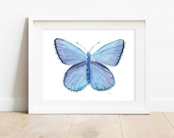 May include: A watercolor painting of a blue butterfly with a white background. The butterfly has a light blue body and wings with darker blue accents. The wings have a scalloped edge.
