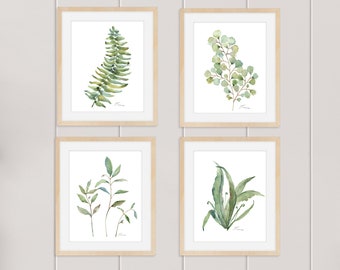 May include: Set of four framed watercolor prints featuring different types of green foliage. Each print has a white background and a simple, handwritten signature in the bottom right corner.