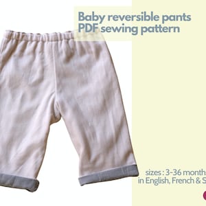 May include: A pair of beige baby pants with a grey cuff. The pants are reversible and have a drawstring waistband. The image includes the text "Baby reversible pants PDF sewing pattern" and "sizes: 3-36 months old in English, French & Spanish".