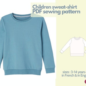 Peut inclure: Patron de couture PDF pour un sweat-shirt pour enfants, disponible en tailles 3-14 ans. Le patron est disponible en français et en anglais. L'image montre un sweat-shirt bleu et un dessin au trait d'un sweat-shirt.