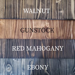 May include: Four wood samples stained in different colors: walnut, gunstock, red mahogany, and ebony.