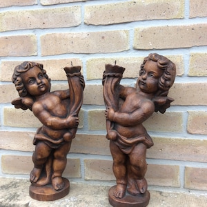 pair of vintage cherub or cherub angel statues
