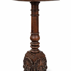 May include: A dark brown wooden pedestal table featuring a square top with rounded edges, a central turned column support, and a square base decorated with carved shell-like motifs resting on four small, rounded feet.