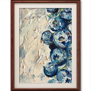 May include: A framed painting featuring a close-up of blueberries. The artwork showcases a textured, impasto style with shades of blue and white. The blueberries are clustered together, set against a textured white background, and framed in a dark brown wooden frame.