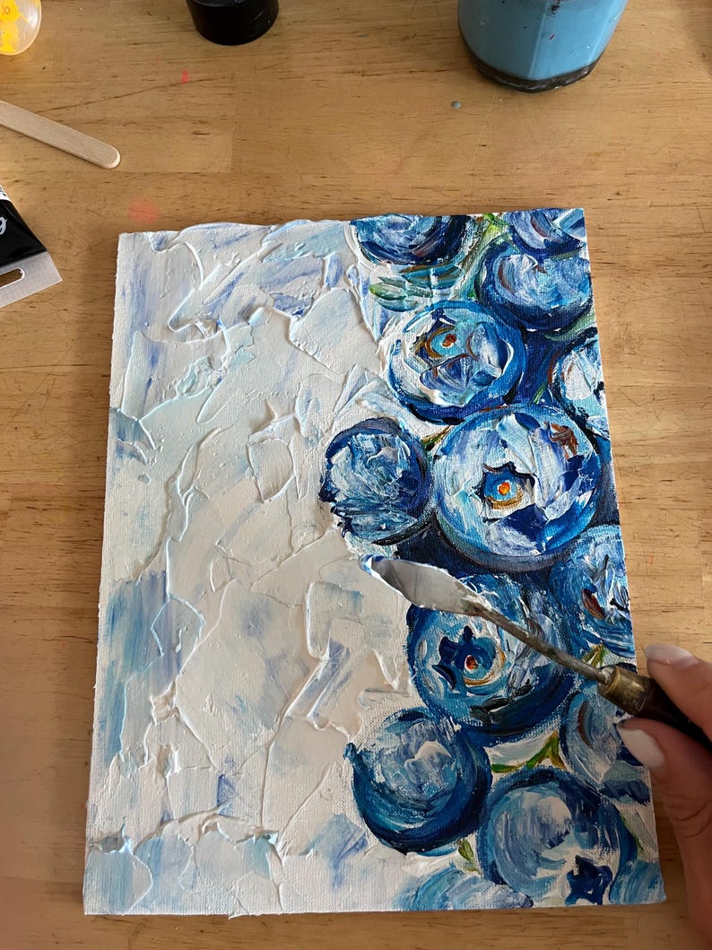 May include: An original painting of blue flowers with a palette knife. The artwork features textured white and light blue paint on a rectangular canvas. The flowers are painted in shades of blue with green accents.