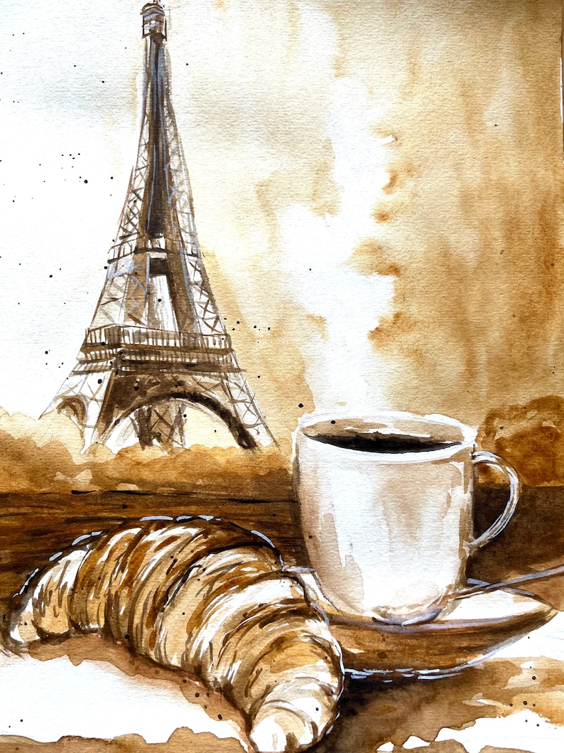 K&ouml;nnte beinhalten: Aquarellmalerei eines Croissants, einer Tasse Kaffee und des Eiffelturms. Das Gem&auml;lde ist in Braun- und Wei&szlig;t&ouml;nen gehalten.