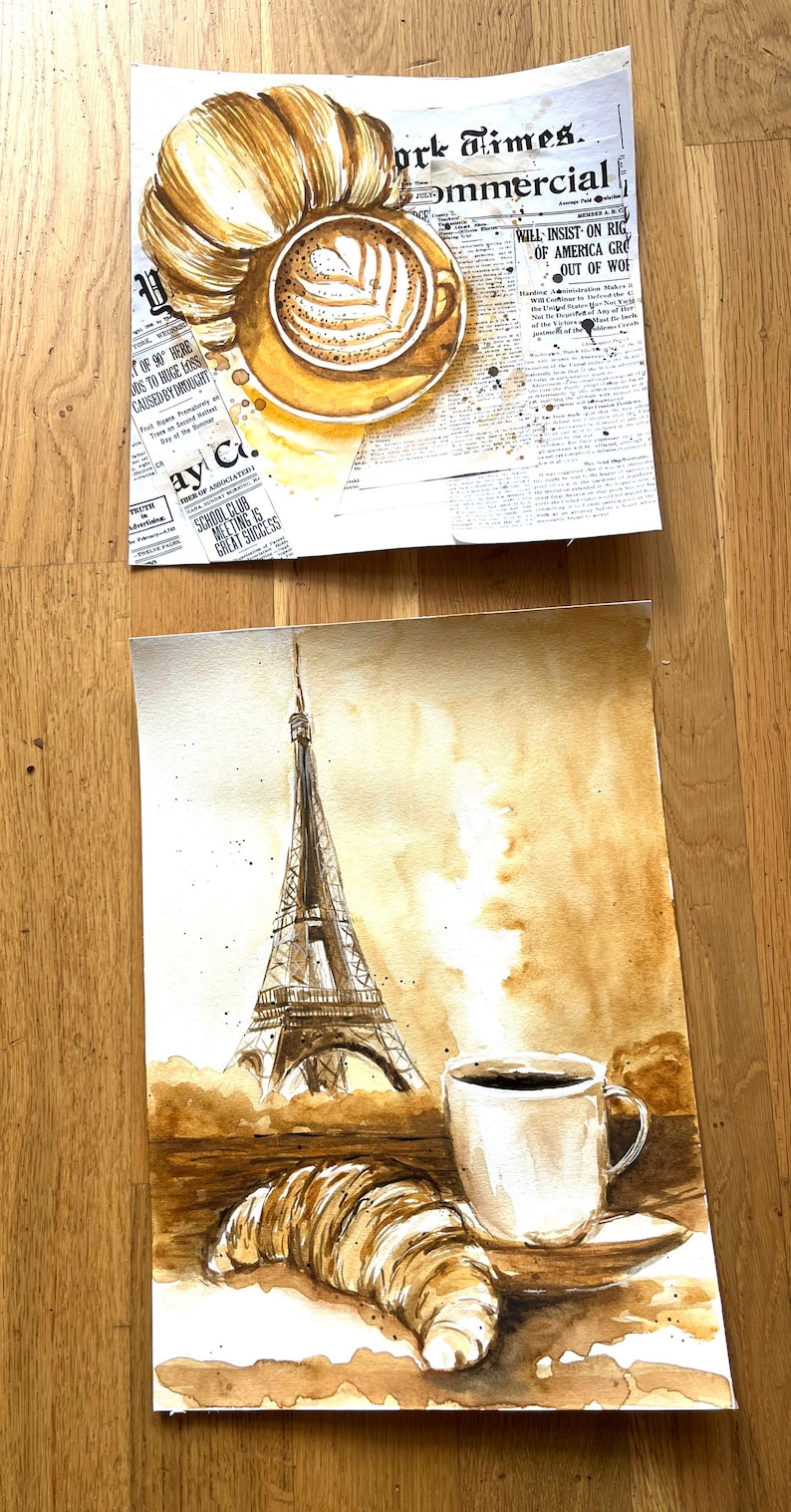 K&ouml;nnte beinhalten: Ein Aquarellbild eines Croissants, einer Tasse Kaffee und des Eiffelturms auf braunem Hintergrund. Das Bild ist im Kaffeefleckenstil gehalten.