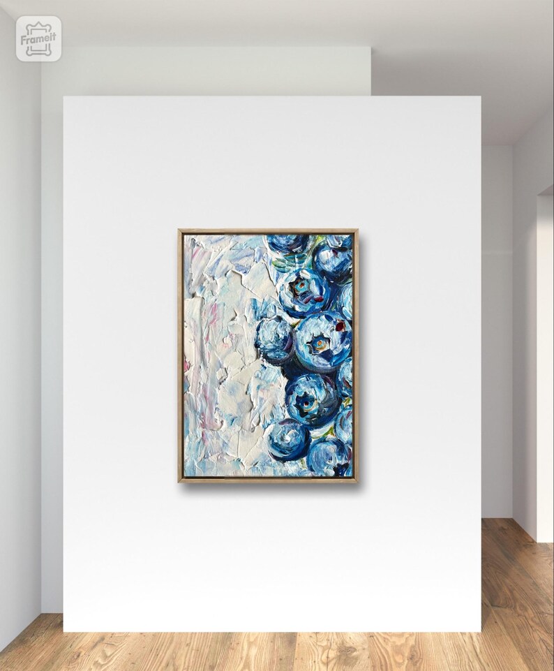 May include: An original oil painting on canvas, featuring a cluster of stylized blue flowers with white and light blue textured brushstrokes. The artwork is framed in a natural wood tone and mounted on a white wall.