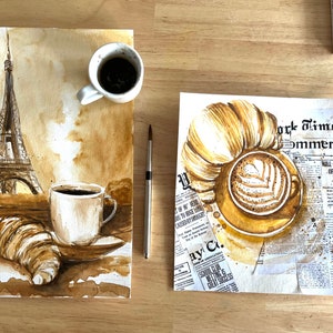 K&ouml;nnte beinhalten: Ein Aquarellbild einer Pariser Szene mit dem Eiffelturm, einem Croissant und zwei Tassen Kaffee. Das Bild ist auf braunem Hintergrund mit einer Zeitungsstruktur gemalt.