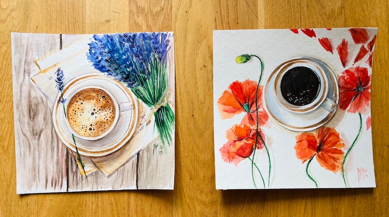 May include: Two watercolor paintings of coffee cups with floral accents. The first painting features a cup of coffee with a lavender bouquet on a wooden surface. The second painting features a cup of coffee with red poppies on a white background.