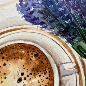 May include: A watercolor painting of a cup of coffee with a brown and white foam on top. A bouquet of lavender flowers is in the background.