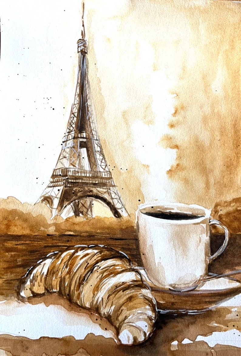 K&ouml;nnte beinhalten: Ein Aquarellbild eines Croissants, einer Tasse Kaffee und dem Eiffelturm im Hintergrund. Das Bild ist in Braun- und Wei&szlig;t&ouml;nen gehalten.