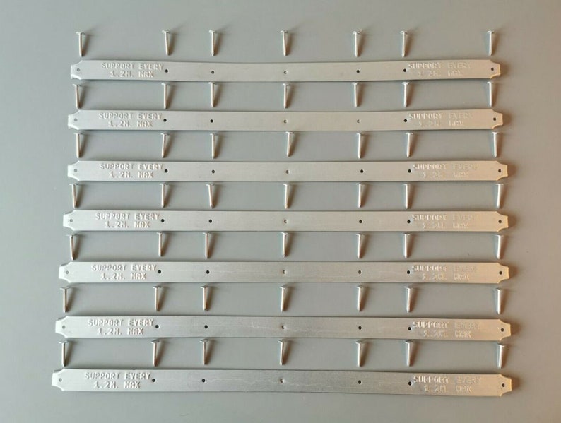 May include: Ten silver metal shelf support brackets with pre-drilled holes. Each bracket has the text "SUPPORT EVERY 1.2H. MAX" printed on it.